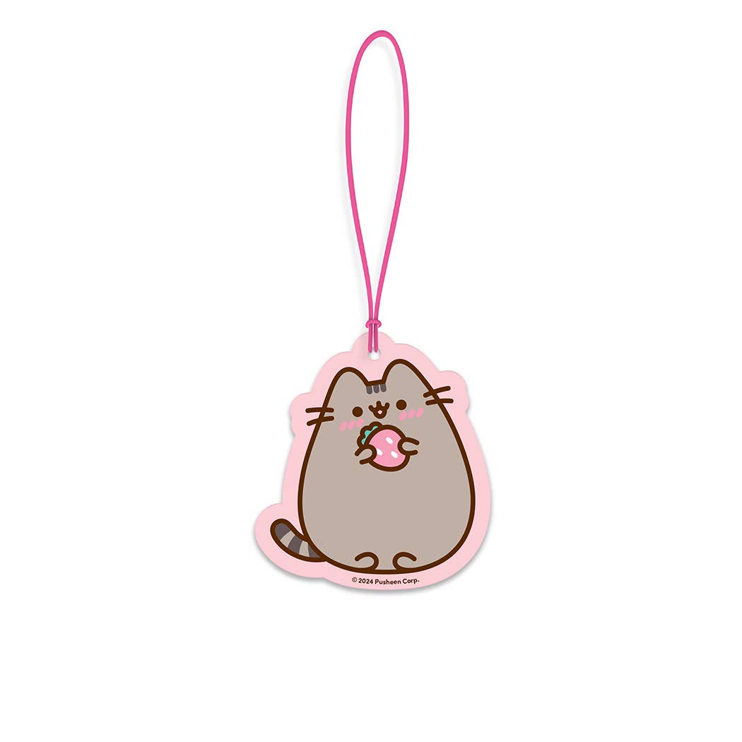 Cartoon cat character car freshener on a pink strap with a white background