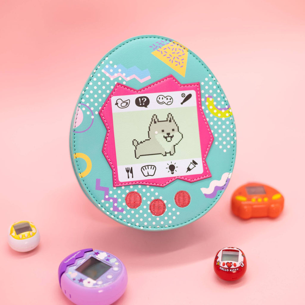 Blue virtual pet crossbody bag with a dog on it with a pink background