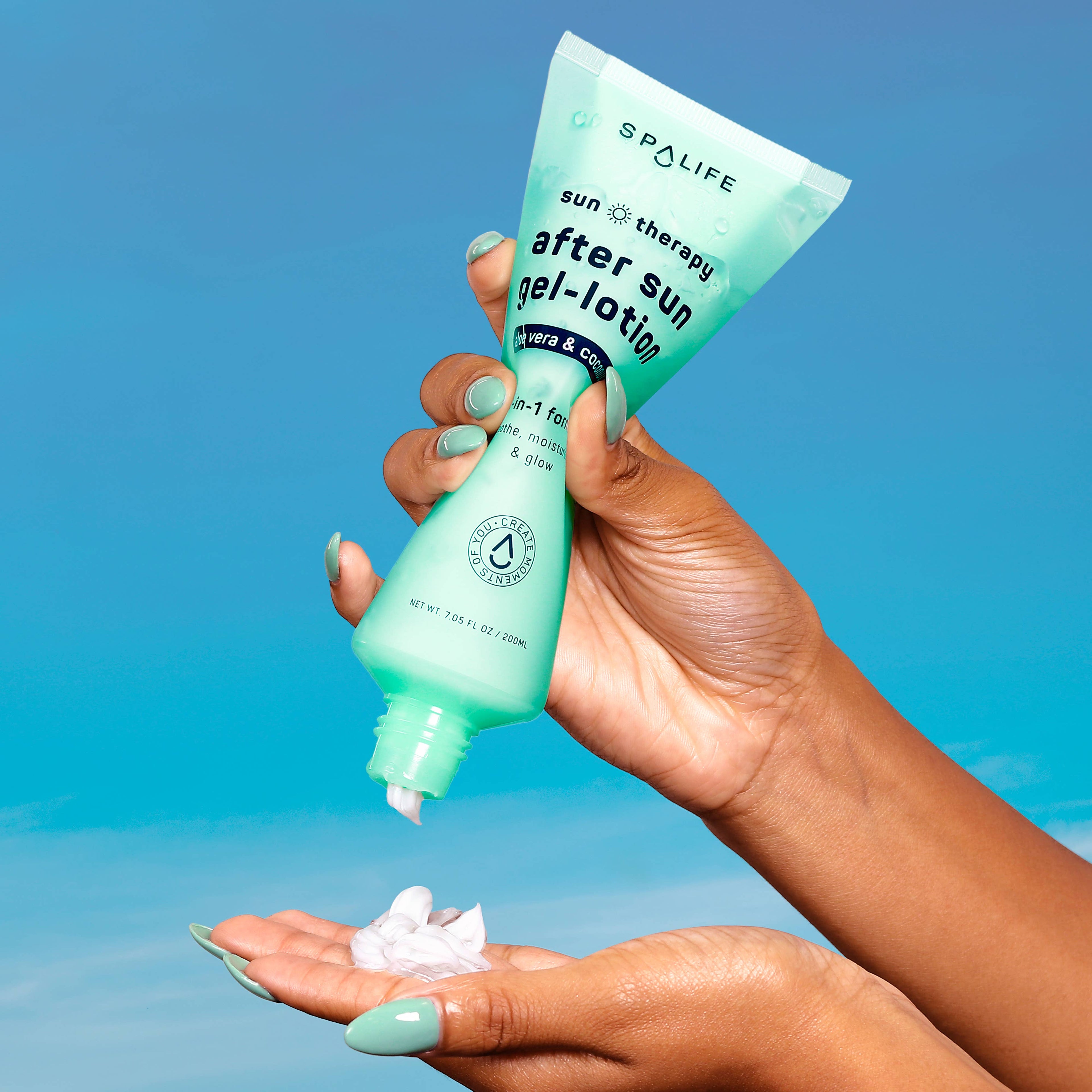 Hand holding a tube of Spalife after sun gel-lotion against a blue background