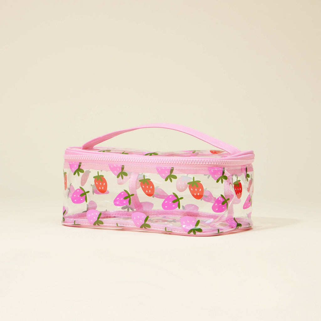 Pink cosmetic bag with strawberry pattern on a beige background