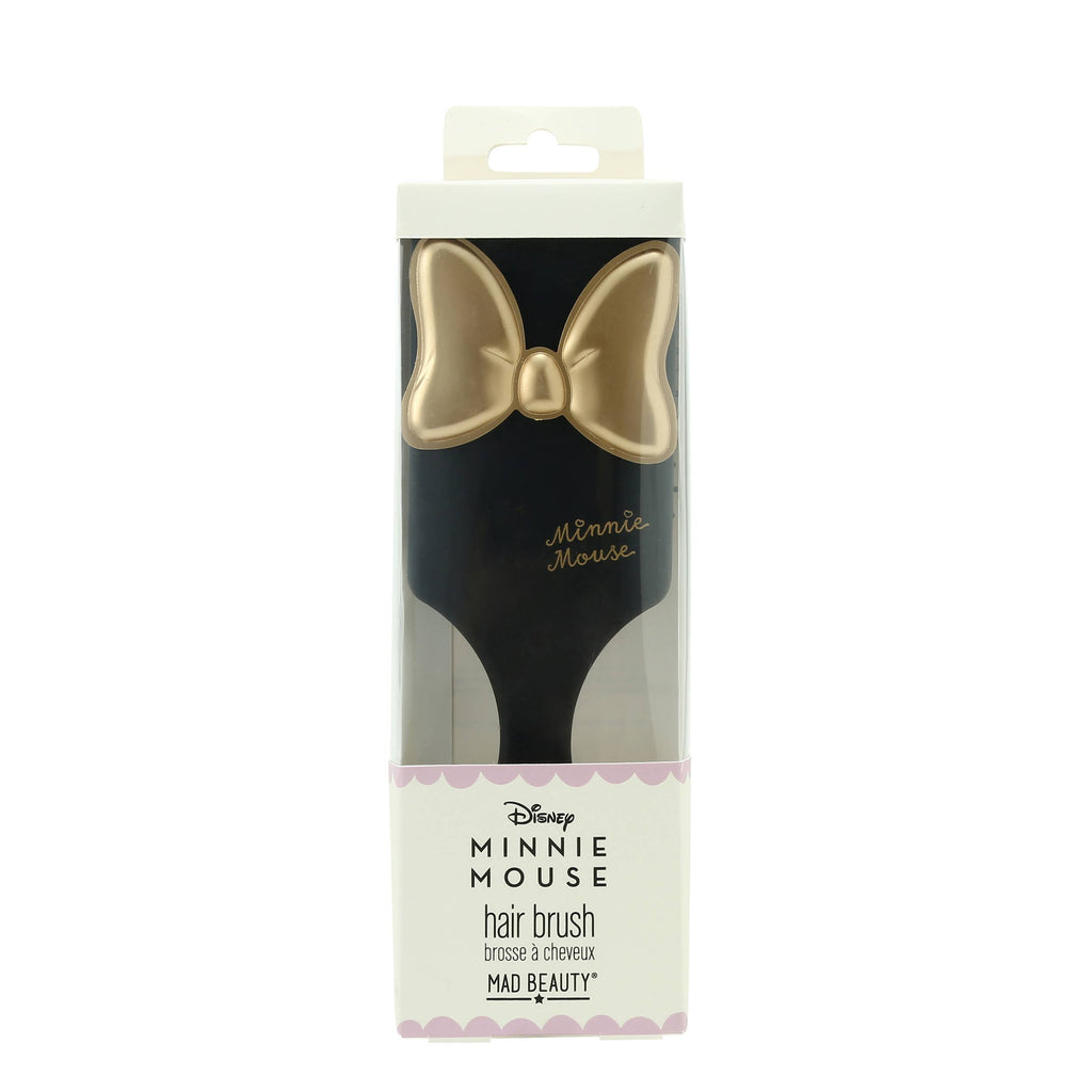 Minnie Mouse hair brush packaging with gold bow design on a white background