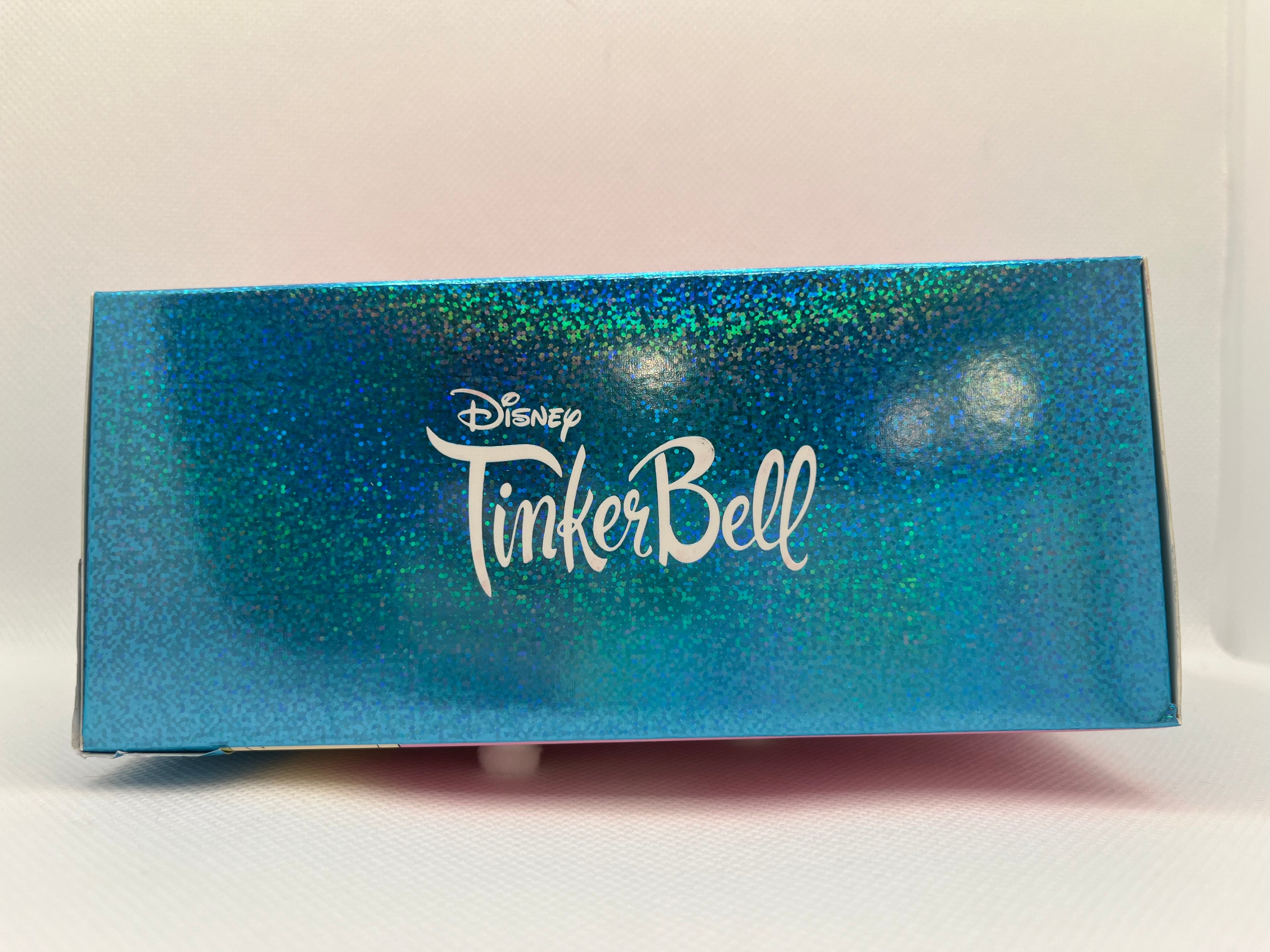 Blue glittery box with 'Disney Tinker Bell' text on a white background