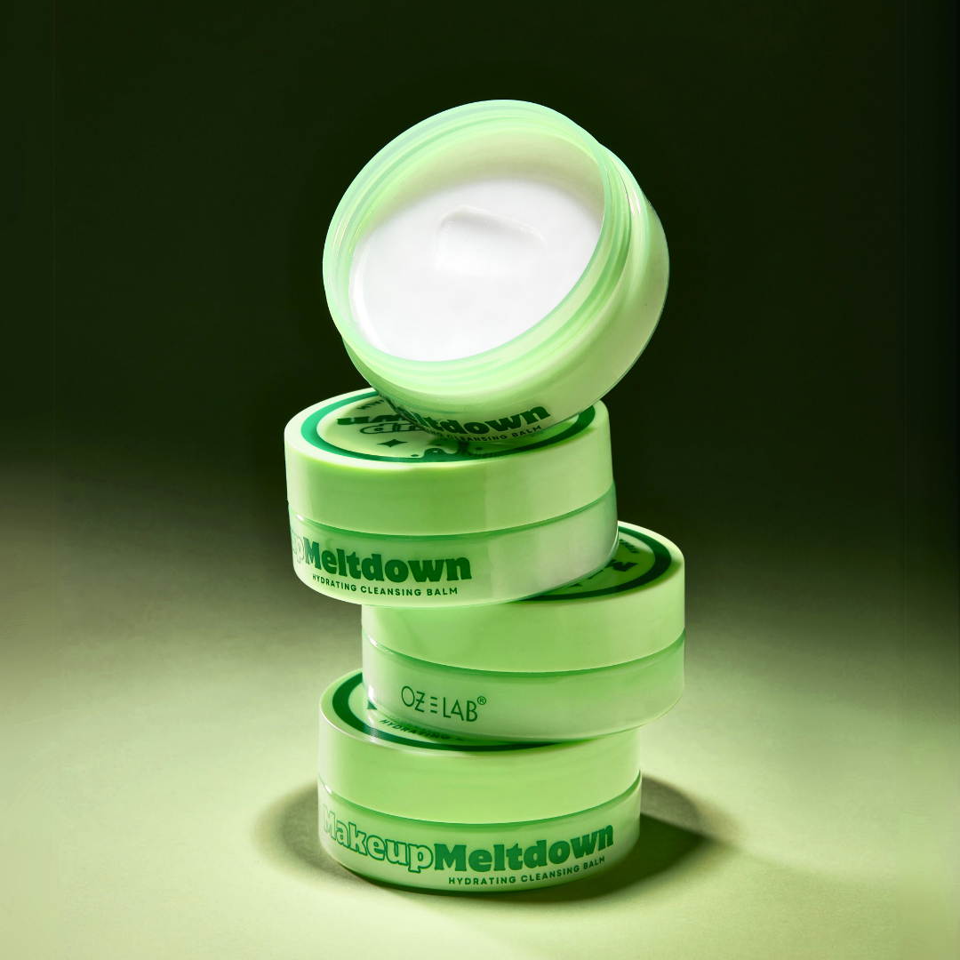 Stack of green containers labeled 'Makeup Meltdown' on a dark background