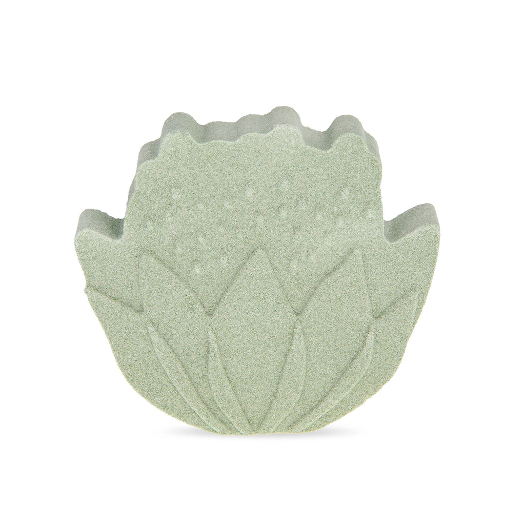 Green leaf-shaped bath bomb on a white background