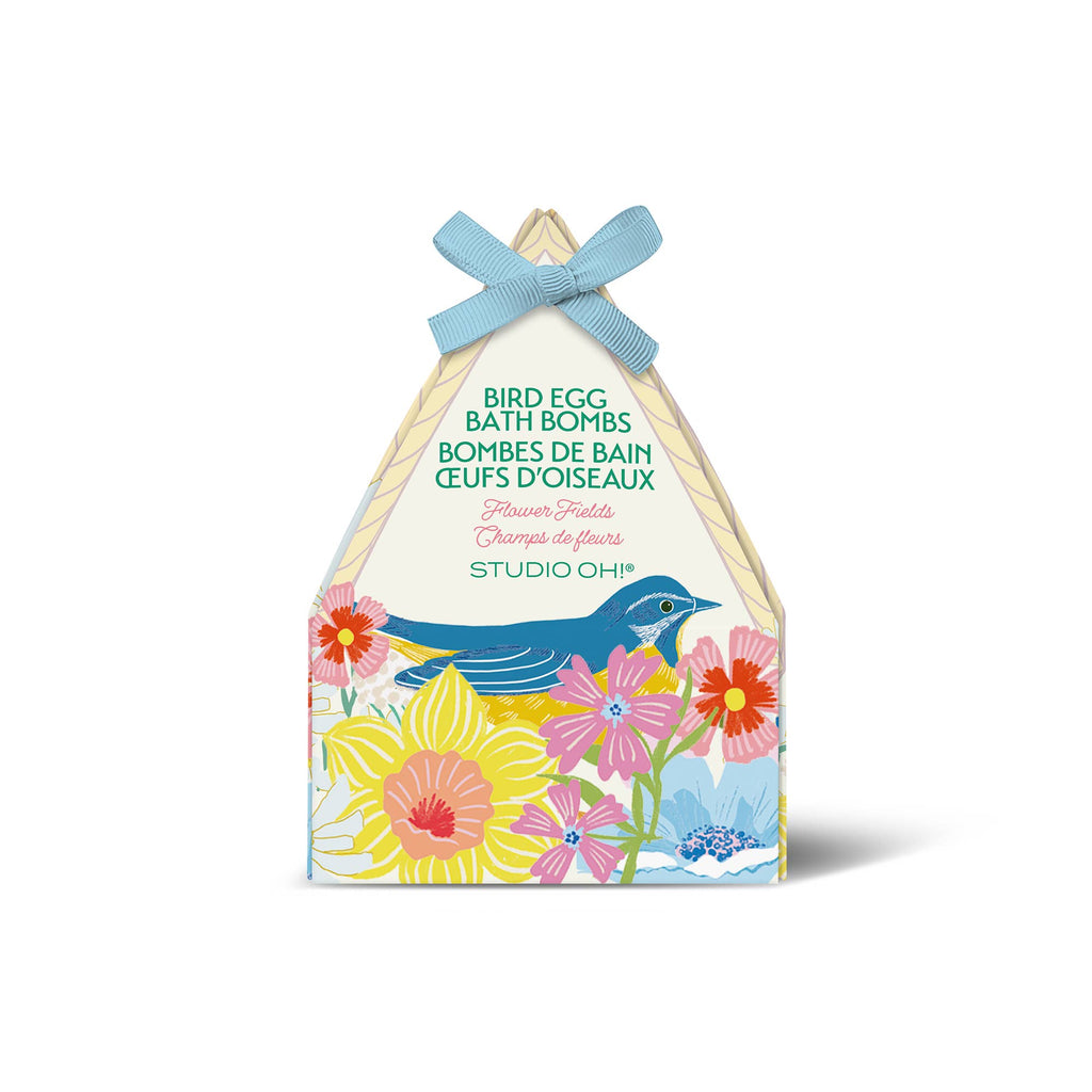 Packaging of Studio Oh! bird egg bath bombs with floral design and blue ribbon on a white background