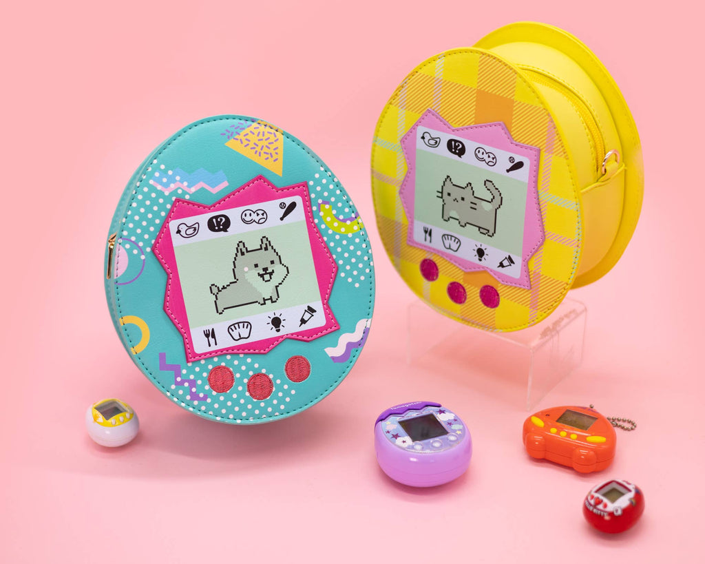 One blue virtual pet crossbody bag with a dog and one yellow virtual pet crossbody bag with a cat on it with a pink background