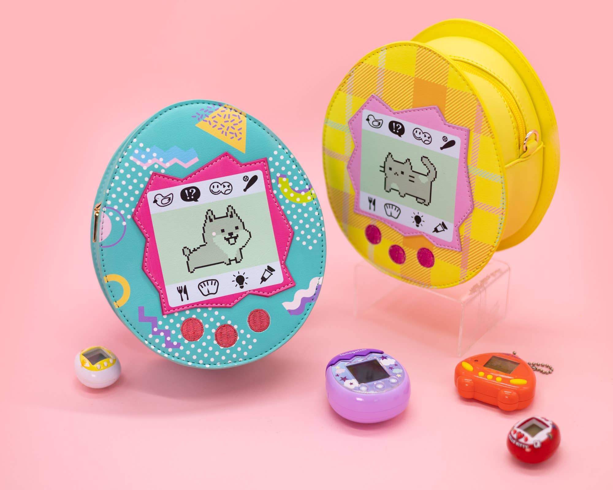 One blue virtual pet crossbody bag with a dog and one yellow virtual pet crossbody bag with a cat on it with a pink background