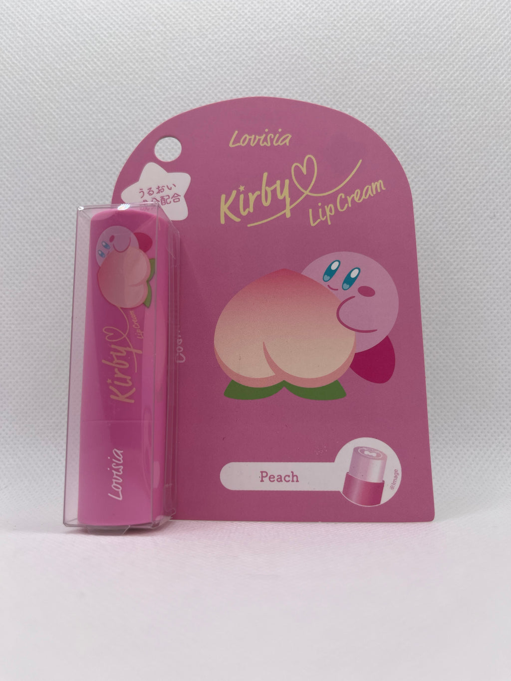 Kirby lip balm in pink packaging against a white background