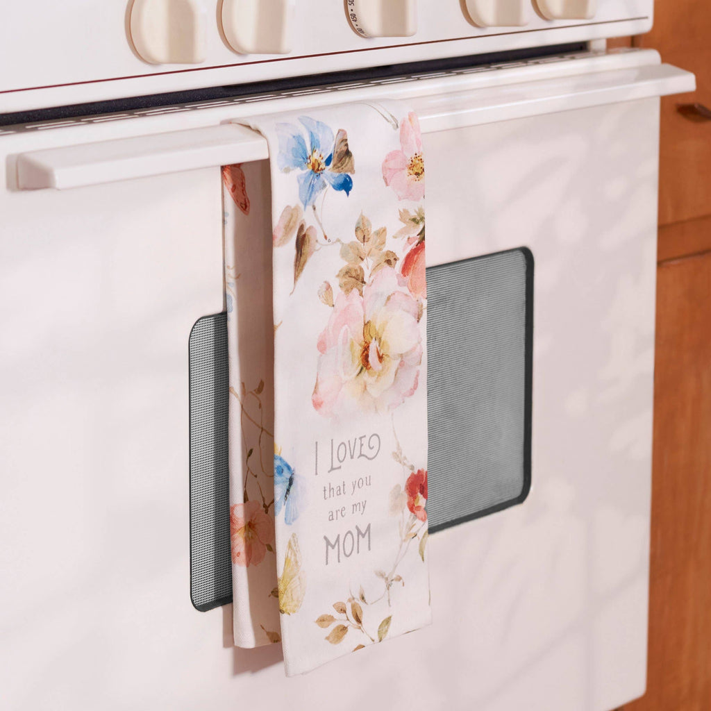Floral towel hanging on a stove handle with text 'I loved you are my mom'.
