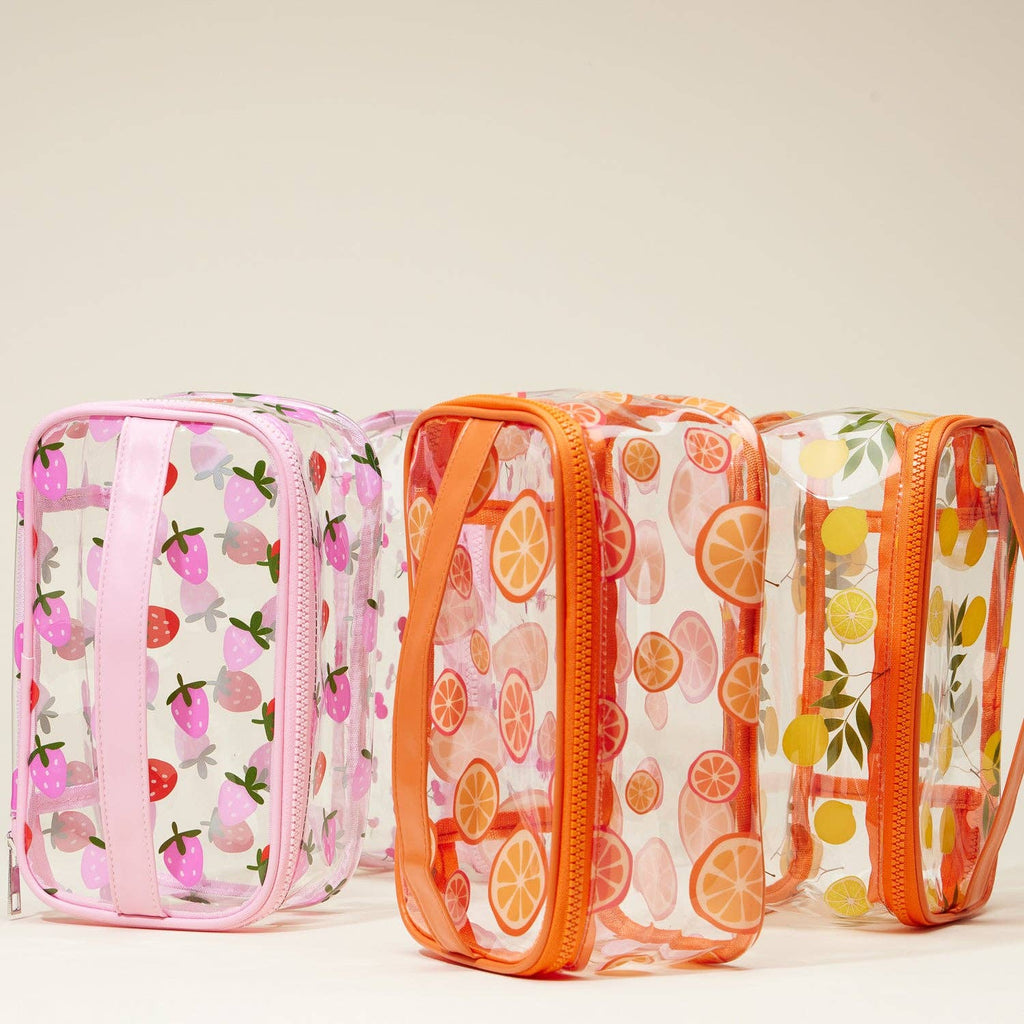 Set of three transparent pouches with fruit patterned sides on a beige background