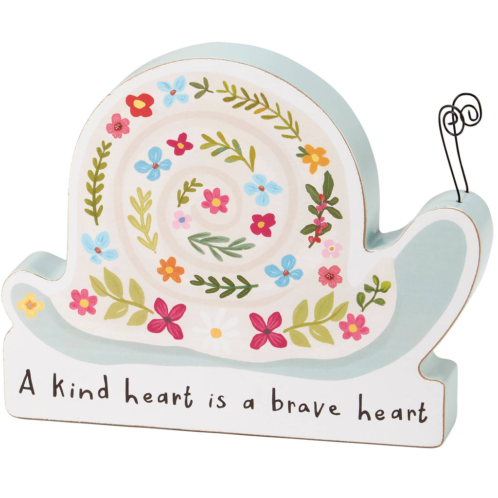 Decorative snail-shaped sign with floral design and motivational quote on a white background