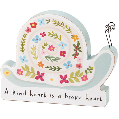 Decorative snail-shaped sign with floral design and motivational quote on a white background
