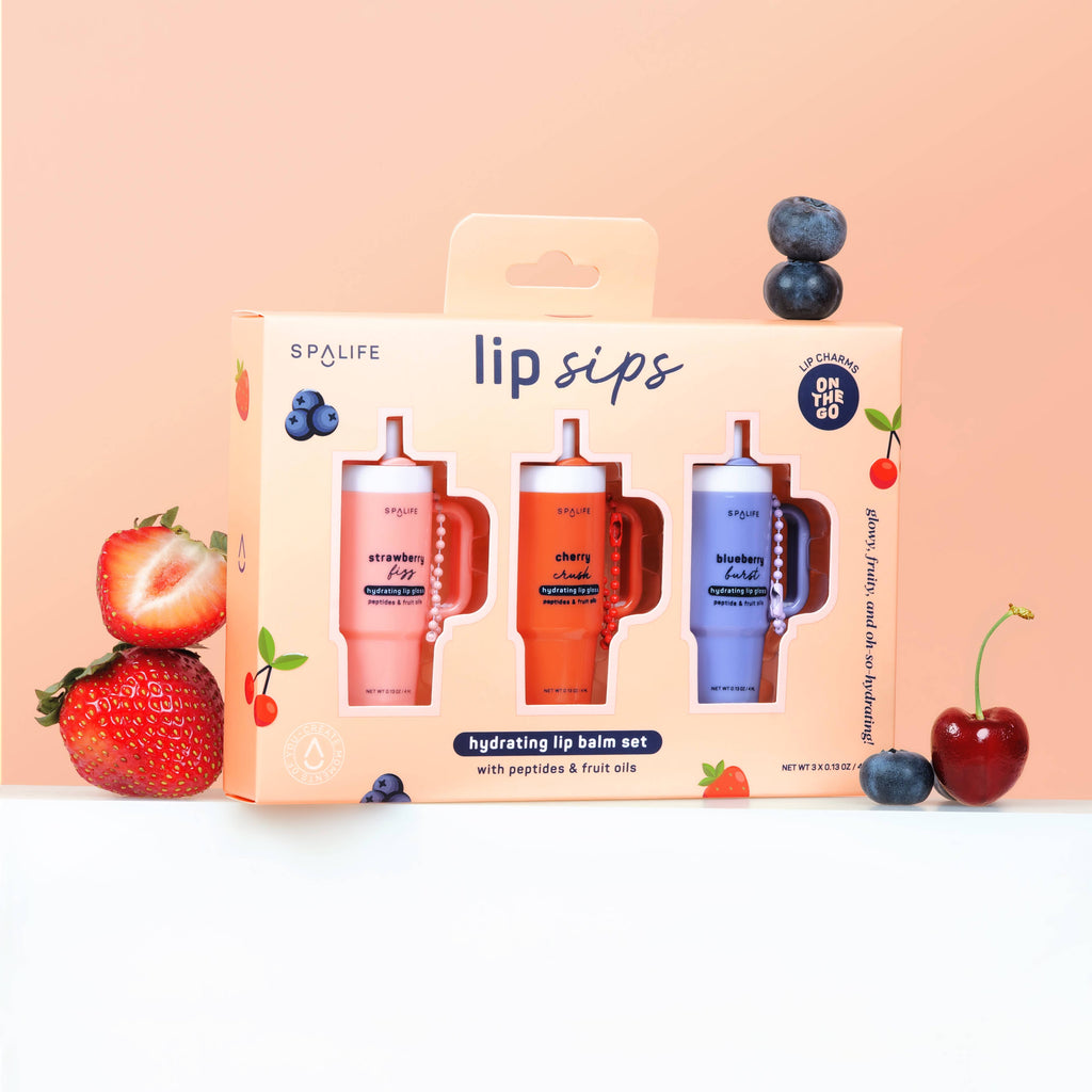 SpaLife lip balm set packaging with lip balms in red, pink, and blue, surrounded by fruits on a peach background.