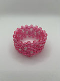 Pink glitter and clear beaded cuff bracelet on a white background.