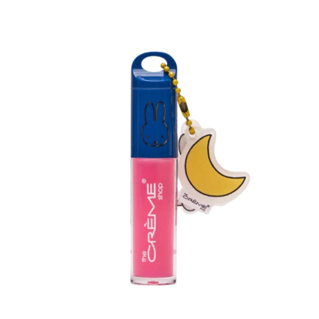 Pink lip oil with blue cap and keychain on a white background