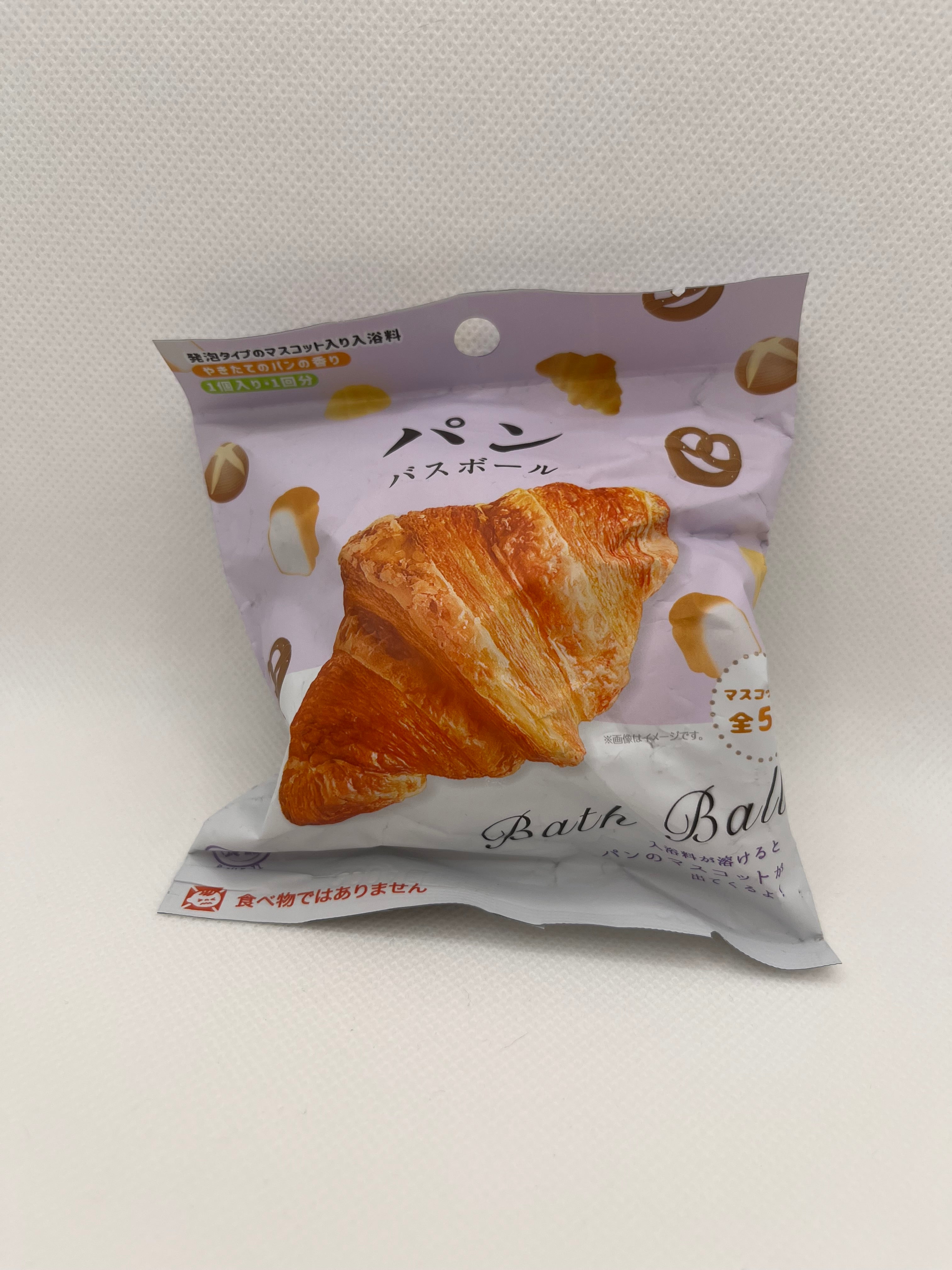 Bread themed bath bomb in packaging against a white background