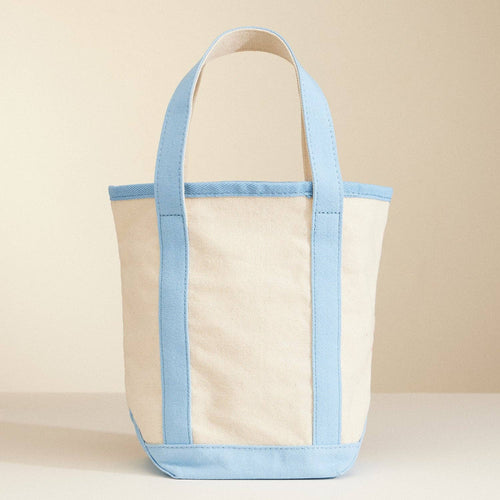 Beige tote bag with light blue accents on a beige background
