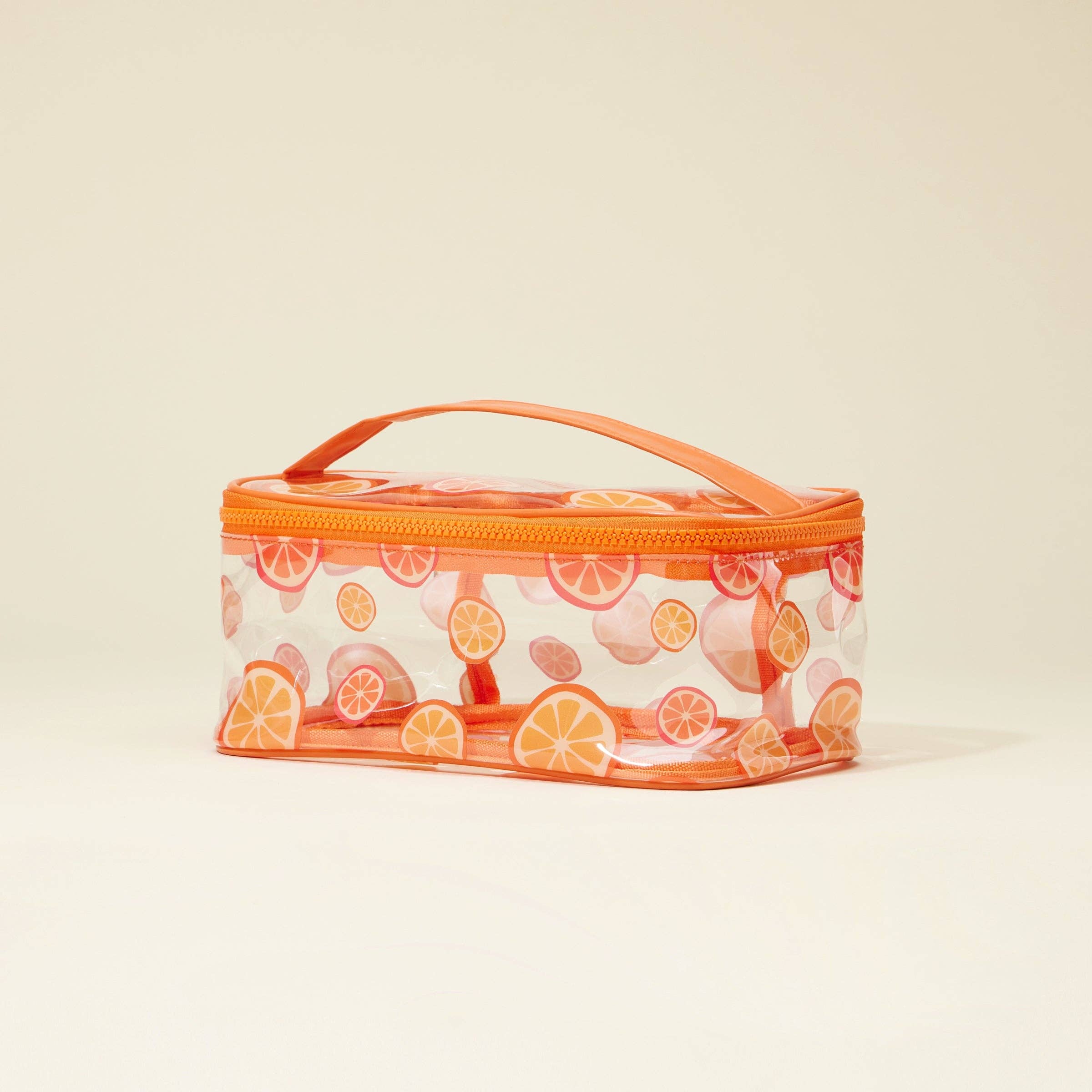 Clear cosmetic bag with orange pattern on a beige background