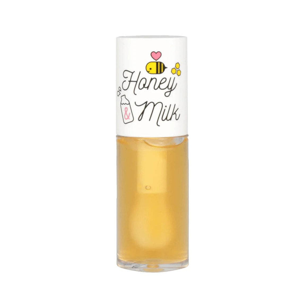 Yellow honey milk lip oil against a white background