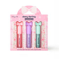 Spa Life dewy darling lip gloss trio packaging with three lip glosses in pink, purple, and green on a white background.