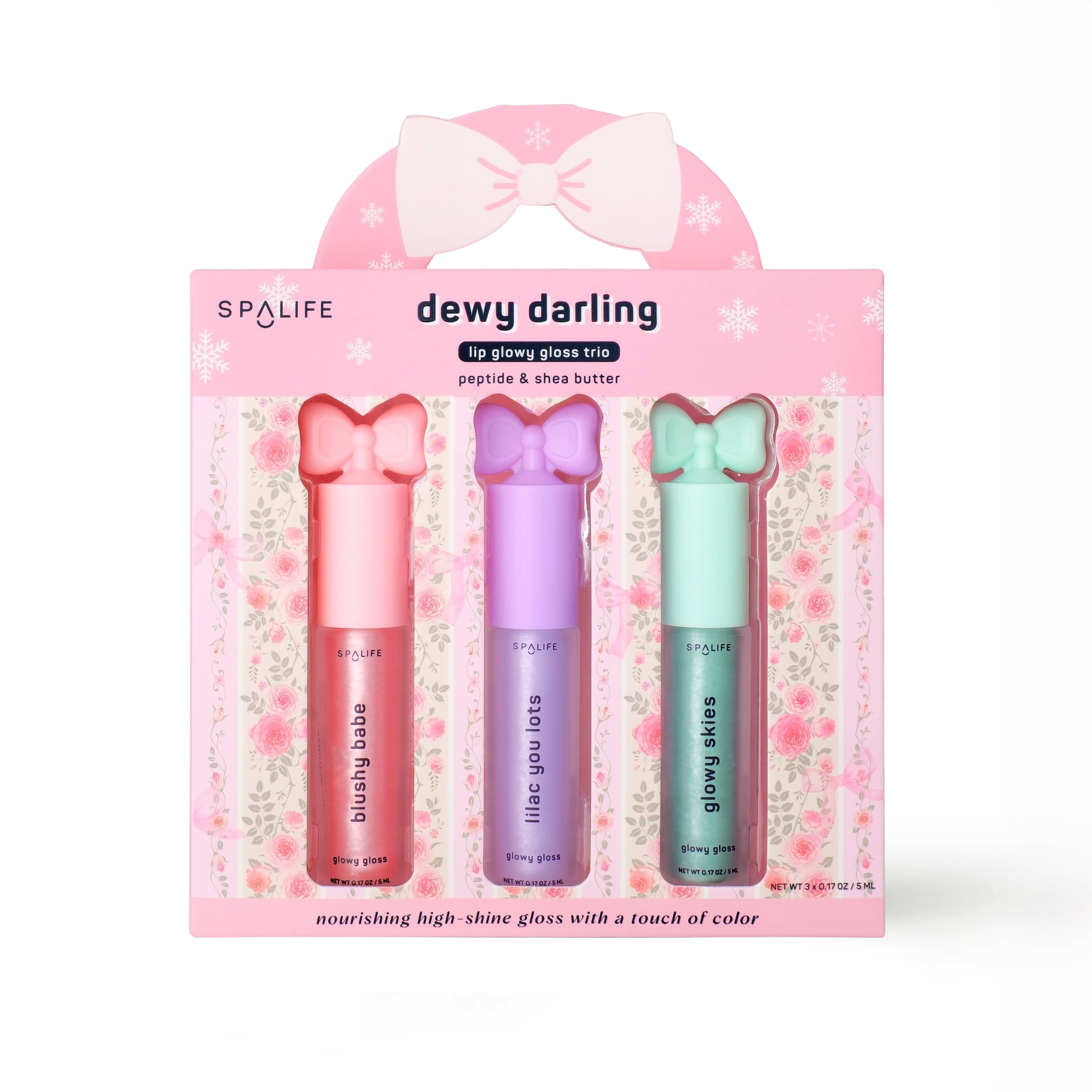 Spa Life dewy darling lip gloss trio packaging with three lip glosses in pink, purple, and green on a white background.