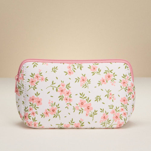 Floral patterned pouch with pink zipper on a beige background