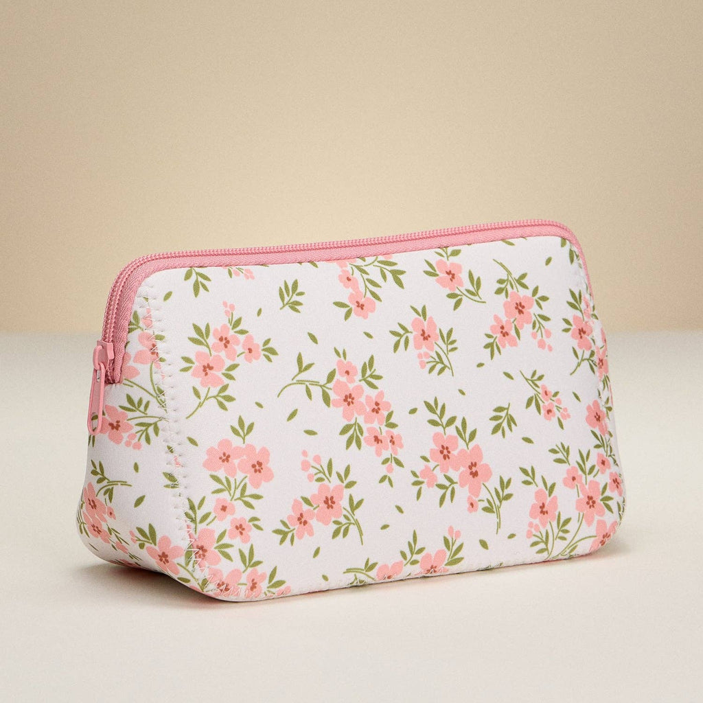 Floral-patterned pouch with pink zipper on a beige background