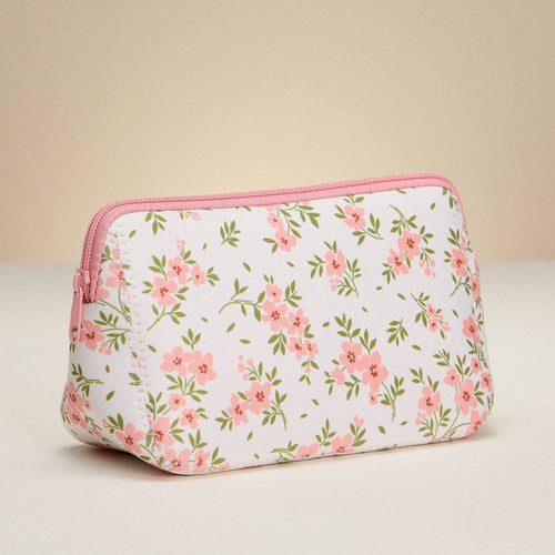 Floral-patterned pouch with pink zipper on a beige background