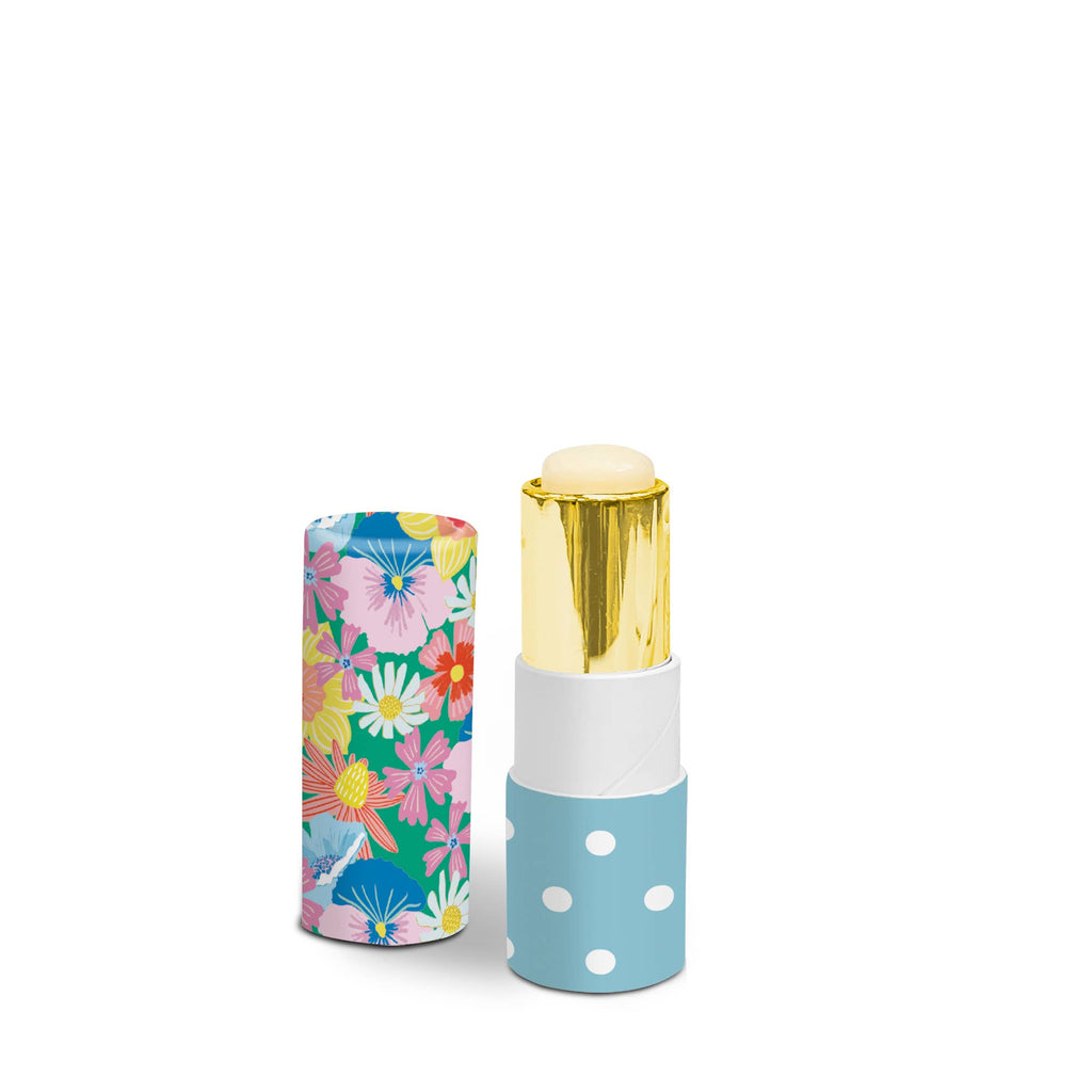 Lip balm with floral-patterned case and gold cap on white background