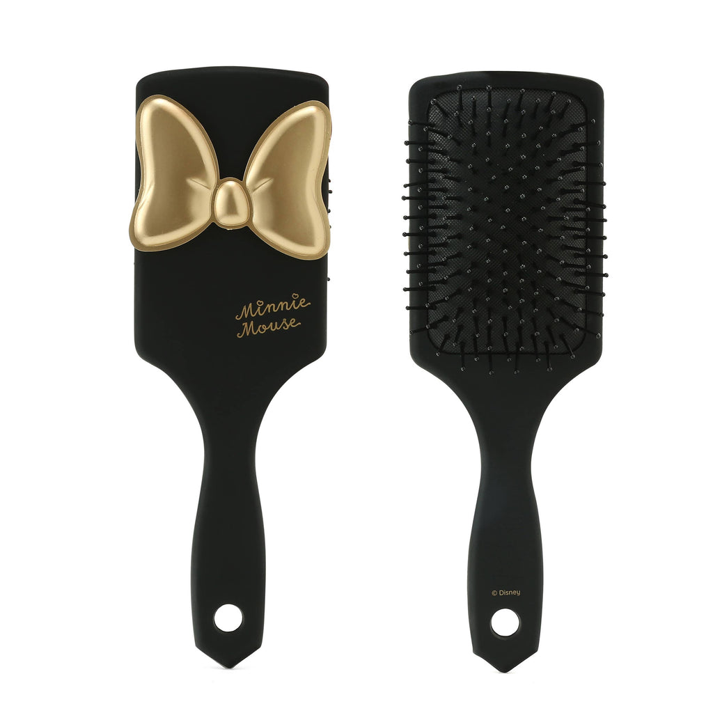 Black hairbrush with gold bow and 'Minnie Mouse' text on a white background